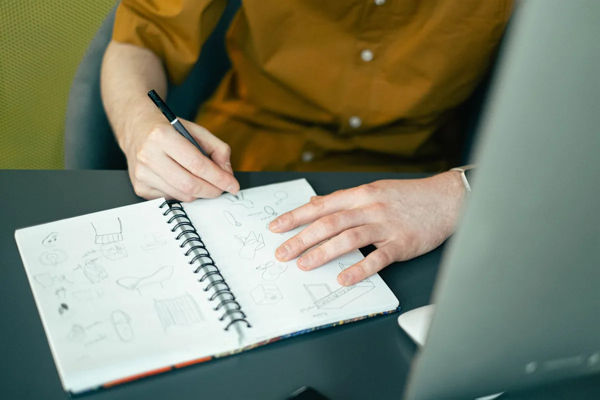 Carnet de brainstorming avec des idées de noms écrits et des croquis pour une marque de t-shirts