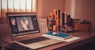 Bureau lumineux avec ordinateur affichant graphiques flous, carnet et calculatrice